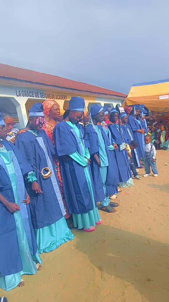 Students wearing blue graduation gowns at the school